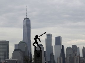 Buildings in Lower Manhattan provide a backdrop to a statue dedicated to the victims of the Katyn massacre of 1940, Friday, May 4, 2018, in Jersey City, N.J. Jersey City Mayor Steve Fulop took to twitter to respond to Stanisław Karczewski, the speaker of the Polish senate, who has criticized Fulop after word got out that the statue will be moved. The memorial will be moved for a renovation of the plaza where it stands. The memorial commemorates the Katyn massacre of tens of thousands of Polish officers by Soviet secret police in 1940.