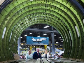 Ontario Liberal leader Kathleen Wynne, right, talks with Michael McCarthy, centre, CEO, of MHI Canada Aerospace Inc., a subsidiary of Japan-based Mitsubishi Heavy Industries as they look in the the haul of an airplane during a campaign stop at the plants facility in Mississauga, Ont., on Wednesday, May 16, 2018.