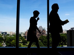 Ontario Liberal leader Kathleen Wynne, left, is silhouetted as she get ready to make an announcement during a campaign stop in Toronto on Monday, May 28, 2018.