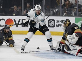 Vegas Golden Knights goaltender Marc-Andre Fleury (29) knocks the puck away from San Jose Sharks center Chris Tierney (50) during the first period of Game 5 of an NHL hockey second-round playoff series, Friday, May 4, 2018, in Las Vegas.