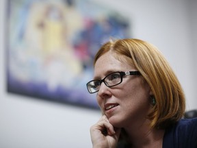 In this May 7, 2018, photo, UNLV associate professor Sheila Bock speaks the with the Associated Press at her office in Las Vegas. Bock has been researching how and why students decorate their caps and says the themes over the years have become increasingly political.  From "Game of Loans, interest is coming" to "Si Se Puede, Here To Stay," graduating college students are choosing to decorate their graduation caps, pushing against the formality of ceremonies and taking a stand on an issue before the thousands watching them cross the stage.