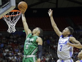 FILE - In this July 3, 2017, file photo, Boston Celtics forward Jayson Tatum (11) lays the ball in as Philadelphia 76ers guard Markelle Fultz (7) defends during an NBA summer league basketball game in Salt Lake City. The Celtics have a 1-0 Eastern Conference semifinal lead over Philadelphia. And Tatum, who was selected third by Boston 11 months ago, has been a revelation on a team battered by injuries. Fultz is not having nearly as much fun. He has been reduced to a spectator after a down regular season that saw him go through shooting issues and miss 68 games with a shoulder injury.