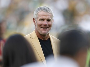 FILE - In this Oct. 16, 2016, file photo, Hall of Fame quarterback Brett Favre is shown during a halftime ceremony of an NFL football game against the Dallas Cowboys, in Green Bay, Wis. Favre says he made three trips to rehabilitation centers to fight his dependence on painkillers and alcohol. Sports Illustrated reports that Favre says he took as many as 14 Vicodin at one time during his MVP season of 1995. The former Green Bay Packers star said "that year, when I woke up in the morning, my first thought was, 'I gotta get more pills.' "