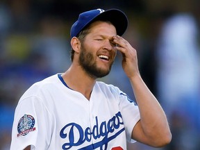 FILE - In this April 25, 2018, file photo, Los Angeles Dodgers starting pitcher Clayton Kershaw wipes his face after giving up a three-run home run to Miami Marlins' Miguel Rojas during the fifth inning of a baseball game in Los Angeles. Dodgers ace Clayton Kershaw was put on the 10-day disabled list with left biceps tendinitis. A three-time NL Cy Young Award winner, Kershaw is on the disabled list for the fourth time.