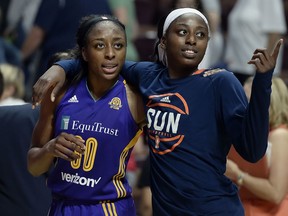 FILE - In this May 26, 2016, file photo, sisters Los Angeles Sparks' Nneka Ogwumike, left, and Connecticut Sun's Chiney Ogwumike, right, walk off the court together at the end of a WNBA basketball game between the their teams, in Uncasville, Conn. Chiney Ogwumike remembers her father always telling her and her sisters that every disappointment is a blessing. The Connecticut Sun star followed that advice, turning two season-ending injuries into what could be a television career. ESPN on Tuesday, May 1, 2018, announced she will be a fulltime basketball analyst. At 26, she is one of the youngest analysts at the network and one of few women in that role.