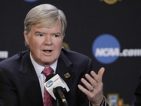 FILE - In this March 30, 2017, file photo, NCAA President Mark Emmert answers a question during a news conference in Glendale, Ariz. The NCAA is opening a door for states with legalized sports gambling to host NCAA championship events. The governing body for college sports on Thursday, May 17, 2018, announced a "temporary" lifting of a ban that prevented events like college basketball's NCAA Tournament from being hosted in states that accept wagers on single games.