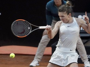 FILE - In this May 19, 2018, file photo, Romania's Simona Halep returns the ball to Russia's Maria Sharapova during their semifinal match at the Italian Open tennis tournament in Rome. Halep will be competing in the French Open tennis tournament that begins on Sunday, May 27.