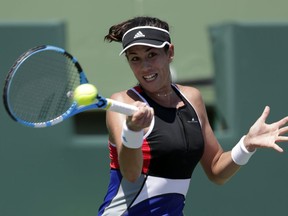 FILE - In this March 26, 2018, file photo, Garbine Muguruza, of Spain, returns to Sloane Stephens during the Miami Open tennis tournament in Key Biscayne, Fla.Muguruza will be competing in the French Open tennis tournament that begins on Sunday, May 27.