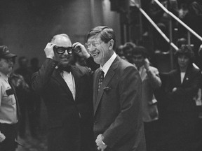 FILE - In this Nov. 20, 1986, file photo, New York Islanders general manager Bill Torrey, left, and former Islanders coach Al Arbour grin as Torrey mimics Arbour's glasses during ceremonies honoring Arbour at the Nassau Coliseum in Uniondale, N.Y. Torrey, the general manager of the New York Islanders when they won four consecutive Stanley Cups in the 1980s and the first president of the Florida Panthers, died Thursday, May 4, 2018. The Panthers and the NHL announced Torrey's death. He was 83.