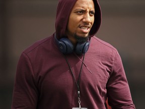 FILE - In this March 22, 2018, file photo, free agent safety Eric Reid watches Stanford NFL Pro Day in Stanford, Calif. The NFL players' union says former San Francisco 49ers safety Eric Reid filed a grievance against the league, alleging that he remains unsigned as a result of collusion by owners. Reid had joined former teammate Colin Kaepernick two seasons ago in kneeling during the national anthem to protest police brutality and racial inequality.