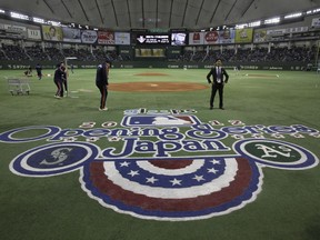 FILE - In this March 28, 2012, file photo, ground staff work prior to the American League season opening Major League Baseball game between the Oakland Athletics and the Seattle Mariners at Tokyo Dome in Tokyo. Oakland and Seattle will play an opening two-game series in Tokyo on March 20 and 21, the fifth time Major League Baseball will start its season in Japan. Oakland will be the home team for both games, Major League Baseball said Tuesday, May 1, 2018.