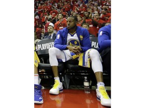 FILE - In this May 16, 2018, file photo, Golden State Warriors forward Andre Iguodala (9) sits on the bench during the final moments of the second half in Game 2 of the NBA basketball Western Conference Finals against the Houston Rockets, in Houston. Iguodala will be out for Game 1 of the NBA Finals on Thursday night, May 31, 2018,  as he recovers from a bone bruise in his left knee that cost him the final four games of the Western Conference finals.