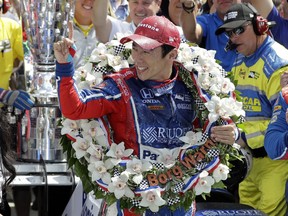 FILE - In this May 28, 2017, file photo, Takuma Sato, of Japan, celebrates winning the Indianapolis 500 auto race at Indianapolis Motor Speedway in Indianapolis. The billboards went up all over Japan when Takuma Sato held off Helio Castroneves in a dramatic Indy 500, becoming the first driver from his nation to win one of motorsport's pinnacle events. Now, after a switch from Andretti Autosport to Rahal Letterman Lanigan Racing, he's back to defend his title this weekend.