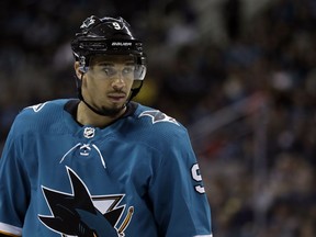 FILE - In this March 20, 2018, file photo, San Jose Sharks' Evander Kane waits for play to resume during the second period of the team's NHL hockey game against the New Jersey Devils in San Jose, Calif. The Sharks are closing in on a seven-year contract with Kane that will keep the high-scoring forward off the free-agent market. A person familiar with the negotiations says the contract is expected to be finalized on Wednesday. The person spoke to The Associated Press on Tuesday night, May 22, on condition of anonymity because the deal hasn't been completed.