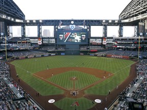 FILE - In this June 18, 2014, file photo, the Arizona Diamondbacks and the Milwaukee Brewers play a baseball game at Chase Field in Phoenix. The Diamondbacks have reached an agreement with Maricopa County that, among other things, would give the franchise the immediate right to explore rebuilding Chase Field or moving to another site. The memorandum of understanding also gives the Diamondbacks complete control of Chase, the downtown ballpark completed when the franchise was born in 1998.