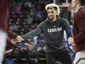 FILE - In this Tuesday, Jan. 16, 2018 file photo, South Carolina's Brian Bowen goofs around with teammates before an NCAA college basketball game in Columbia, S.C. Brian Bowen is staying in the NBA draft after South Carolina was told by the NCAA he would have to miss at least all of next season before playing for the Gamecocks. Bowen announced his decision through the school Wednesday, May 30, 2018.