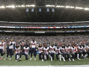 FILE - In this Oct. 29, 2017, file photo, Houston Texans players kneel and stand during the singing of the national anthem before an NFL football game against the Seattle Seahawks, in Seattle. NFL owners have approved a new policy aimed at addressing the firestorm over national anthem protests, permitting players to stay in the locker room during the "The Star-Spangled Banner" but requiring them to stand if they come to the field. The decision was announced Wednesday, May 23, 2018, by NFL Commissioner Roger Goodell during the league's spring meeting in Atlanta.