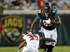 FILE - In this Thursday, Aug. 17, 2017 file photo, Jacksonville Jaguars tight end Marcedes Lewis (89) makes a move to get around Tampa Bay Buccaneers cornerback Javien Elliott (35) during the second half of an NFL preseason football game in Jacksonville, Fla. Marcedes Lewis wasn't sure if the Green Bay Packers were the right fit for him. Quarterback Aaron Rodgers and tight end Jimmy Graham made him feel comfortable at Lambeau Field.