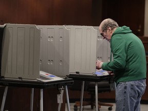 In this Friday, April 27, 2018 photo, a voter prepares his ballot during early voting at the Hamilton County Government Center in Noblesville, Ind. The U.S. Department of Homeland Security is facing a backlog of requests for comprehensive cybersecurity reviews of state election systems. Among those still waiting is Indiana, which is one of four states with primaries on Tuesday, May 8, 2018.