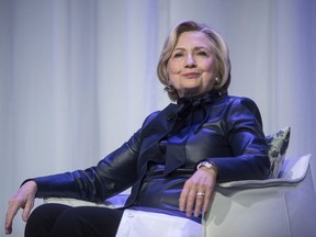 FILE - In this Wednesday, Dec. 13, 2017 file photo, Hillary Clinton sits on stage during a book tour event in Vancouver, British Columbia, Canada. On May 11, 2018, The Associated Press has found that stories circulating on the internet that Clinton is New York's new attorney general are untrue.