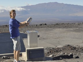 This undated photo provided by NOAA in May 2018 shows Mauna Loa Observatory scientist Aidan Colton, a NOAA employee who fills flasks and maintains instruments at the MLO in Hawaii. According to a study released on Wednesday, May 16, 2018, scientists say since 2013, there's more of a banned chlorofluorocarbon (CFC) going into the atmosphere, and measurements from a dozen monitors around the world, including the MLO, suggest the emissions are coming from somewhere around China, Mongolia and the Koreas.