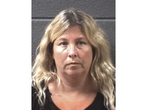 This 2015 booking photo provided by the Buncombe County Bureau of Identification shows Jennifer Warren after she was caught illegally collecting thousands of dollars' worth of food stamps. Founder of the Recovery Connections Community rehab program, Warren put participants to work baby-sitting her children and cleaning her home while she vacationed in Paris and New Orleans, records show. She used the nonprofit's money to buy hundreds of exotic pets, according to former participants and state records. She diverted donations – salon appointments and concert tickets – to herself and used participants' food stamps to stock her own kitchen, interviews and documents from two state probes show. (Buncombe County Bureau of Identification via AP)