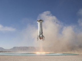 FILE - In this Tuesday, Dec. 12, 2017 photo provided by Blue Origin, the New Shepard booster lands in west Texas during a test. On Thursday, May 24, 2018, President Donald Trump signed a space policy directive asking the government to make it easier for private companies to get to and from space. (Blue Origin via AP)