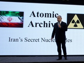 FILE - In this Monday, April 30 2018, file photo, Israeli Prime Minister Benjamin Netanyahu presents material on Iran's purported nuclear program in Tel Aviv. Netanyahu displayed what he said was a trove of Iranian nuclear documents collected by Israeli intelligence. The Mossad, long shrouded in mystery and mythology, is legendary in international intelligence circles for being behind what are believed to be some of the most daring covert operations.