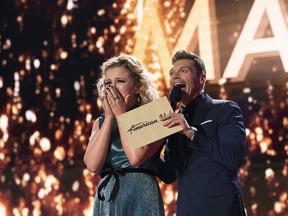 In this May 21, 2018 photo provided by ABC, Maddie Poppe, left, reacts with Ryan Seacrest after being announced the winner of "American Idol" in Los Angeles. The singer-songwriter bested Caleb Lee Hutchinson and Gabby Barrett in the two-hour finale on ABC.