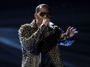FILE - In this June 30, 2013, file photo, R. Kelly performs onstage at the BET Awards at the Nokia Theatre in Los Angeles. A woman filed a lawsuit Monday, May 21, 2018, in New York against R. Kelly, claiming the singer sexually assaulted her. He has long been the target of sexual misconduct allegations, which he has denied.