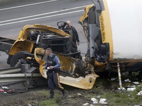FILE - In this May 17, 2018, file photo, emergency personnel work at the scene of a school bus and dump truck collision on Interstate 80 in Mount Olive, N.J. Hudy Muldrow Sr., the school bus driver caused the fatal crash by crossing three lanes of traffic in an apparent attempt to make an illegal U-turn, according to a criminal complaint released Thursday, May 24, that charged him with vehicular homicide.