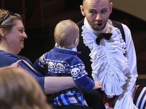 Anna Hayman, left, holds one-year-old Marcus Emmett as he listens to Timothy Connor perform in "BambinO," a Scottish opera designed for an audience 6 to 18 months old, Tuesday May 1, 2018, at the Metropolitan Opera House in New York.