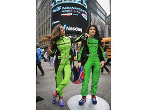 Race driver Danica Patrick, left, pose with a life-size Lego statue creation of herself, Tuesday, May 22, 2018, in New York. Lego master builder Chris Steininger says it took him 200 hours to build, using under 15,000 pieces and 13 different colors.