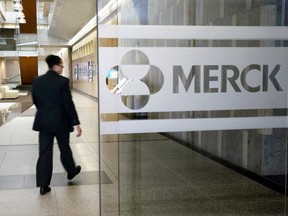 FILE - In this Dec. 18, 2014, file photo, a person walks through a Merck company building, in Kenilworth, N.J. Merck & Co. reports earnings Tuesday, May 1, 2018.