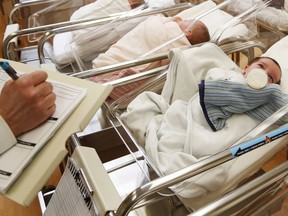 FILE - This Feb. 16, 2017 file photo shows newborn babies in the nursery of a postpartum recovery center in upstate New York. Women in the United States gave birth last year at the lowest rate in three decades, a trend that could weigh on economic growth in future decades. The number of babies born in the U.S. has fallen for three straight years, and as births decline and the population ages, fewer Americans are available to work or start businesses, thereby slowing the economy.