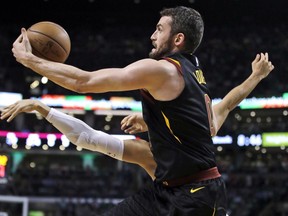 FILE - In this Wednesday, May 23, 2018, file photo, Cleveland Cavaliers center Kevin Love (0) grabs a pass against Boston Celtics forward Jayson Tatum during Game 5 of the NBA basketball Eastern Conference finals in Boston. On the edge of his fourth straight NBA Finals, but just the third when healthy enough to play, Cleveland's All-Star forward has persisted and prevailed during a season in which he bravely revealed suffering from anxiety and panic attacks much of his life.