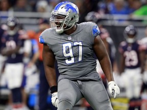 FILE - In this Dec. 16, 2017, file photo, Detroit Lions defensive tackle Akeem Spence (97) reacts after a sack during the second half of an NFL football game against the Chicago Bears in Detroit. Spence has been acquired by the Miami Dolphins from the Detroit Lions for an undisclosed 2019 draft pick, the Dolphins announced Thursday, May 3, 2018.