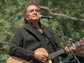 FILE - In this May 23, 1993 file photo, country legend Johnny Cash performs at a benefit concert at Central Park in New York. Cash's first gold record for the recording of "I Walk the Line" is now available for viewing at the Johnny Cash Museum in Nashville, Tenn. Bill Miller, the founder of the museum, purchased it from a private collector in Germany earlier this year.