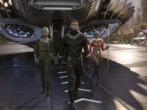 This image released by Disney shows Lupita Nyong'o, left, and Chadwick Boseman and Danai Gurira in a scene from Marvel Studios' "Black Panther." The global smash hit garnered seven nominations for the  MTV Movie & TV Awards, including one for Boseman. The awards will be held on June 18. (Matt Kennedy/Marvel Studios-Disney via AP)