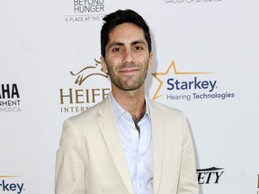 FILE - In this Aug. 22, 2014 file photo, Nev Schulman, executive producer of the MTV series "Catfish: The TV Show," arrives at the 3rd Annual Beyond Hunger "A Place At The Table" gala in Beverly Hills, Calif.  MTV has temporarily suspended shooting the show while it investigates sexual misconduct accusations made by a woman who appeared on air three years ago. Schulman denied the allegations in a statement Thursday, May 17, 2018.
