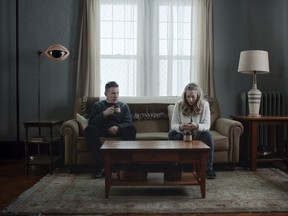 This image released by A24 shows Ethan Hawke, left, and Amanda Seyfriend in a scene from "First Reformed." (A24 via AP)