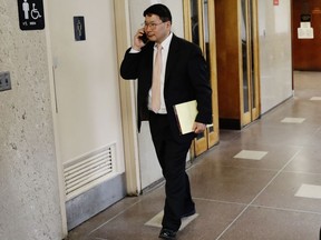 In this April 27, 2018 photo, Dr. Robert Rho walks the hallway in Queens County Criminal Court in New York. A jury in the Queens borough of New York heard closing arguments Tuesday, May 1, 2018, in the manslaughter case against Rho, who presided over an abortion procedure that went horrifically wrong that resulted in his patient bleeding to death.