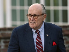 FILE - In this Nov. 20, 2016 file photo, former New York Mayor Rudy Giuliani arrives at the Trump National Golf Club Bedminster clubhouse in Bedminster, N.J. President Donald Trump's new lawyer Rudy Giuliani said Wednesday, May 2, 2018, the president repaid attorney Michael Cohen for a $130,000 payment to porn star Stormy Daniels. Giuliani made the revelation during an appearance on Fox News Channel's "Hannity."