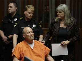 FILE - In this April 27, 2018, file photo, Joseph James DeAngelo, accompanied by Sacramento County Public Defender Diane Howard, right, makes his first appearance to face charges that include homicide and rape, in Sacramento County Superior Court in Sacramento, Calif. A judge is considering whether to make public search and arrest warrants for DeAngelo, a man who authorities call one of California's most elusive serial killers. DeAngelo is due back in court Monday, May 14, for a routine hearing.