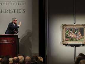 Global president of Christie's Jussi Pylkkanen taps the gavel on the podium for the final sale of Henri Matisse's "Odalisque couchee aux magnolias" for $71.5 million during an auction from the collection of Peggy and David Rockefeller, Tuesday, May 8, 2018, in New York.