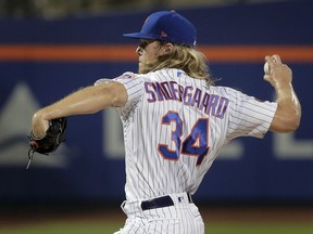 New York Mets pitcher Noah Syndergaard (34) delivers against the Toronto Blue Jays during the first inning of a baseball game, Tuesday, May 15, 2018, in New York.