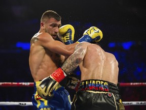 Vasiliy Lomachenko, left, of Ukraine, at left, throws a right at Jorge Linares, of Venezuela, during their WBA lightweight championship boxing match Saturday, May 12, 2018, in New York.