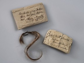 This 2017 photo provided by Fort Ticonderoga shows a lock of Benedict Arnold's hair along with the paper wrappings that have enclosed it, at Fort Ticonderoga, in Ticonderoga, N.Y. The hair will be exhibited for one weekend only, Saturday and Sunday, May 5-6, 2018, at the New York fort Arnold helped capture in opening weeks of the Revolutionary War. The fort's curator said the lock, donated by a direct of descendant of Arnold's in 1952, was wrapped in paper, top, inscribed by Arnold's son Henry and enclosed in another paper, right, addressed to Henry and his brother, who were living in Canada.
