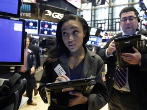 Trader Lauren Simons works on the floor of the New York Stock Exchange, Monday, May 21, 2018. Stocks are opening solidly higher on Wall Street after trade tensions between the U.S. and China dissipated.