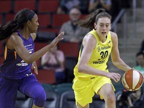 FILE - In this Tuesday, May 8, 2018, file photo, Seattle Storm's Breanna Stewart, right, races up the court with Phoenix Mercury's Chelsea Nelson in the second half of a WNBA exhibition basketball game in Seattle. Several months earlier, Stewart revealed that she was sexually abused as a child. The Seattle Storm star is partnering with RAINN (Rape, Abuse and Incest National Network) to give back and raise awareness.